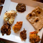 From 12 o'clock clockwise: dal makhani, whole wheat roti, subz handi, kade masale gosht (spicy lamb), butter chicken, rajma masala, murgh malai